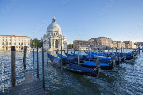 Fototapeta Naklejka Na Ścianę i Meble -  Gondolas moored by Saint Mark square with San Giorgio di Maggiore church in the background - Venice, Venezia, Italy, Europe