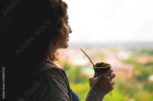 Woman watching the window with her Chimarrão - Rio Grande do Sul - South of Brazil.