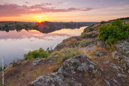 Sunset on the rocky shore of Dnieper river, Khortytsia island, Zaporizhzhia, Ukraine