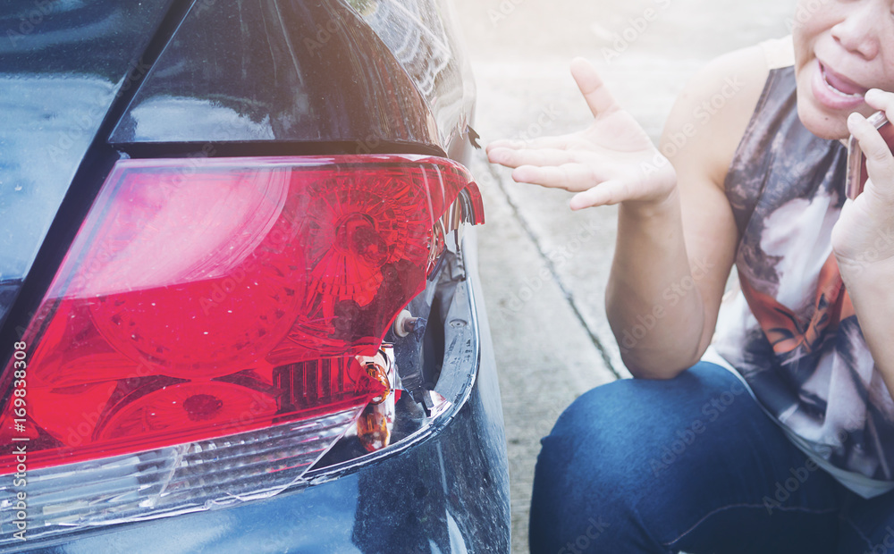 Fotografie Lady using phone calling insurance agent for car accident claim process