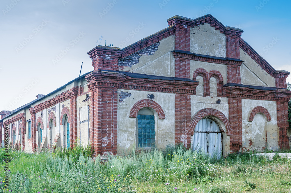 Facade of an old factory building / Abandoned glass factory in Tugustemir settlement, Orenburg region, Russia Facade of an old factory building / Abandoned glass factory in Tugustemir settlement, Orenburg region, Russia