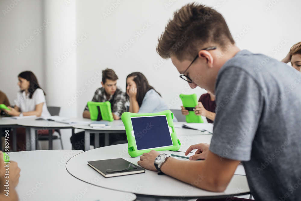 High School Students Using Tablets in Round Classroom High School Students Using Tablets in Round Classroom