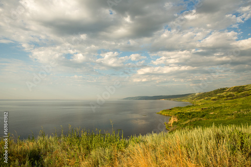 river  landscape  green meadow. the cliff and the sky