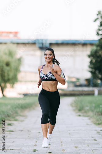 Beautiful athletic woman running outdoors