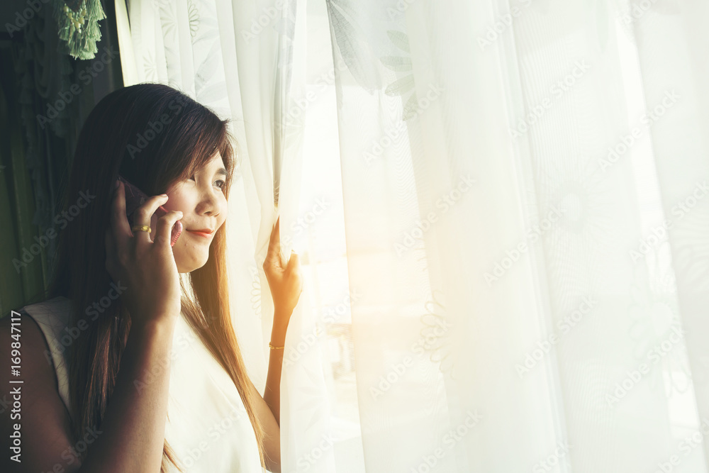 Beautiful young woman talking by telephone indoors. Beautiful young woman talking by telephone indoors.