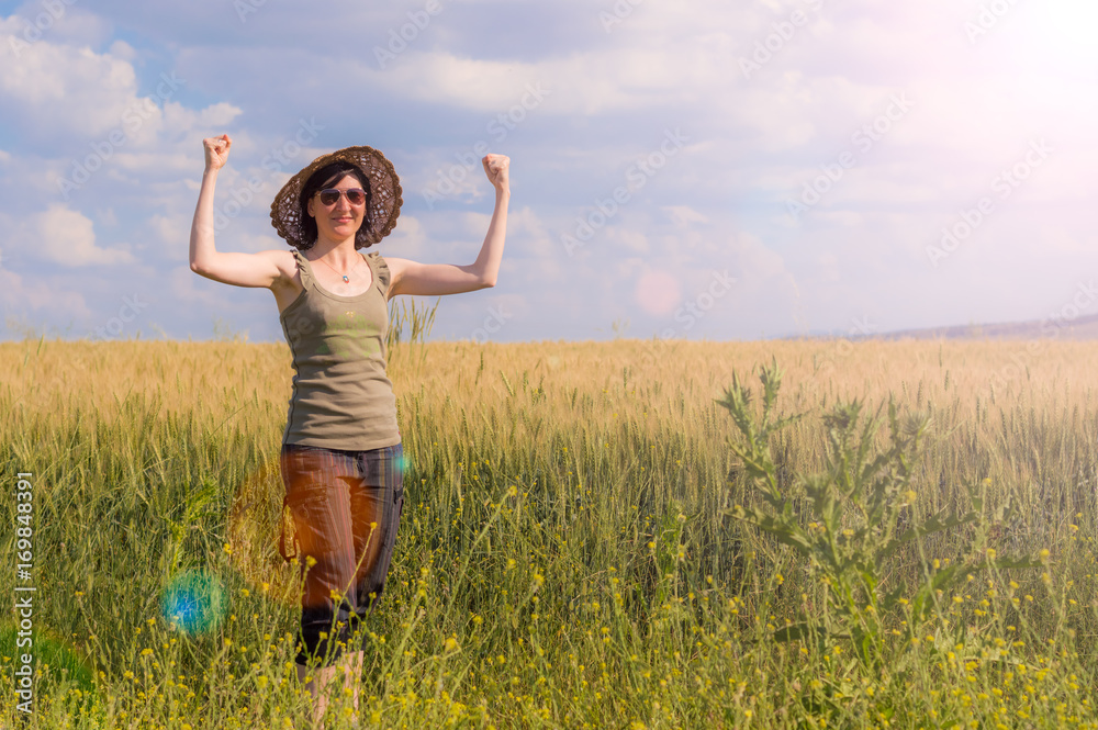 Young woman with hat enjoying the nature. Victory concept. Young woman with hat enjoying the nature. Victory concept.