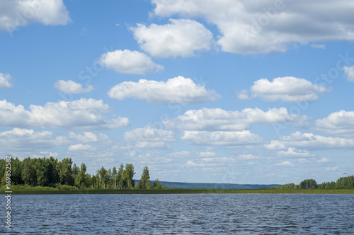 Summer clouds river reeds trees photo