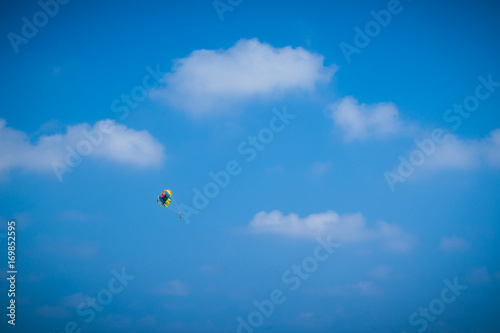 Parasailing high up in the blue sky 