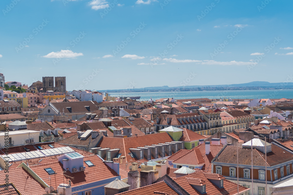 Orange tiles roofs in lisbon, Portugal, typical houses, panorama with the Tagus river in background
