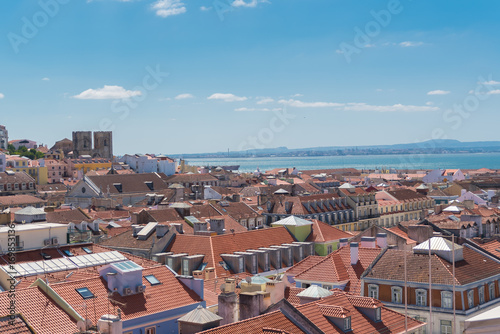 Orange tiles roofs in lisbon, Portugal, typical houses, panorama with the Tagus river in background 