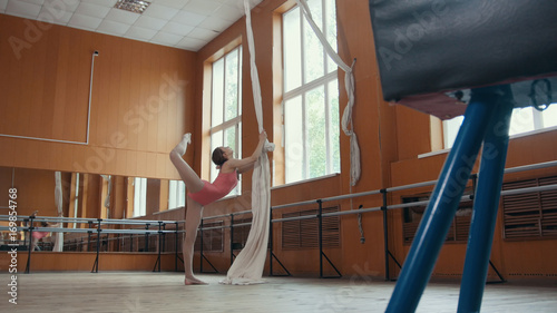 Girl Ballet Dancer Training in mirror room - pink suit