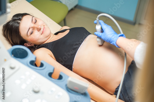 Ultrasound machine doctor s hand usg investigation USCG  pregnant woman