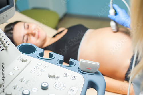 Ultrasound machine doctor"s hand usg investigation USCG, pregnant woman