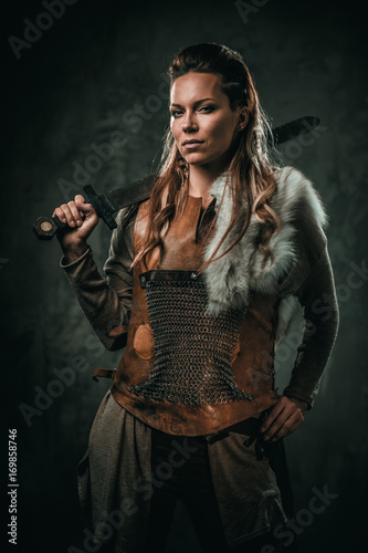 Viking woman with cold weapon in a traditional warrior clothes © Nejron Photo