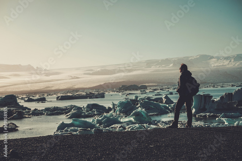 Woman explorer lookig at Jokulsarlon lagoon  Iceland.