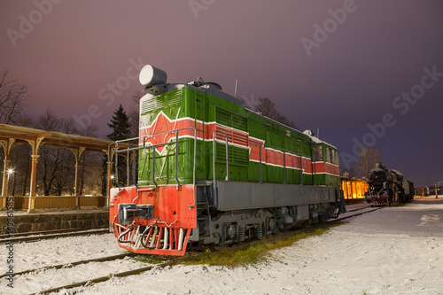 Old train at vintage station. Winter time.