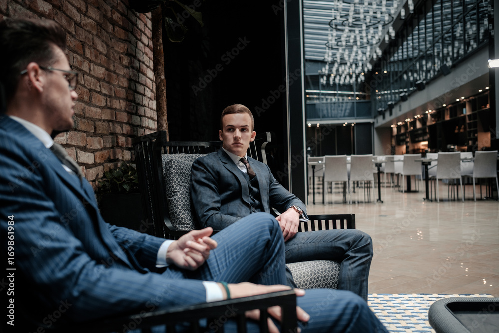 Two young gentleman having conversation Two young gentleman having conversation