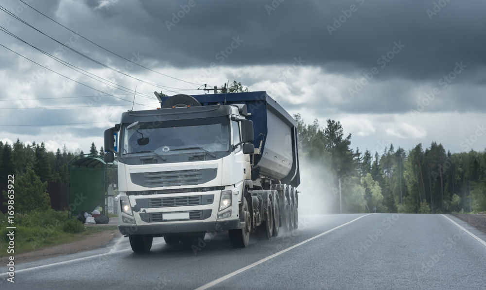 big dump truck goes in the evening on highway big dump truck goes in the evening on highway