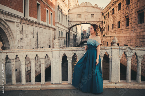 Woman in front of Bridge of Sighs in Venice