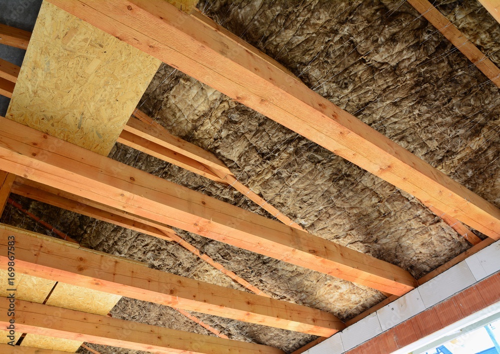 Roof and attic insulation over wooden beams in a new house. Roof and attic insulation over wooden beams in a new house.