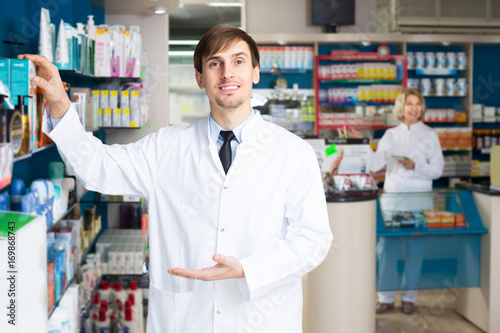 Portrait of two pharmacists working in modern farmacy