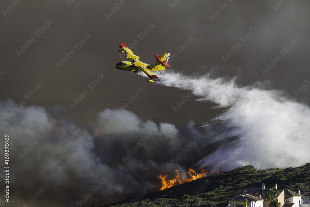 Ταπετσαρία Wild fire close to houses being fought with airplanes and helicopters