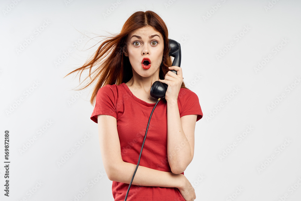 woman calling on a black landline phone, emotions, empty space for copying woman calling on a black landline phone, emotions, empty space for copying