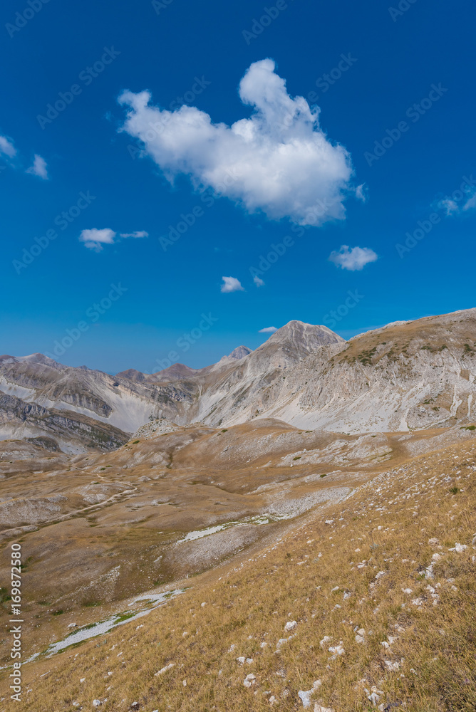 A high mountain range with peaks and plateaus on a warm summer day