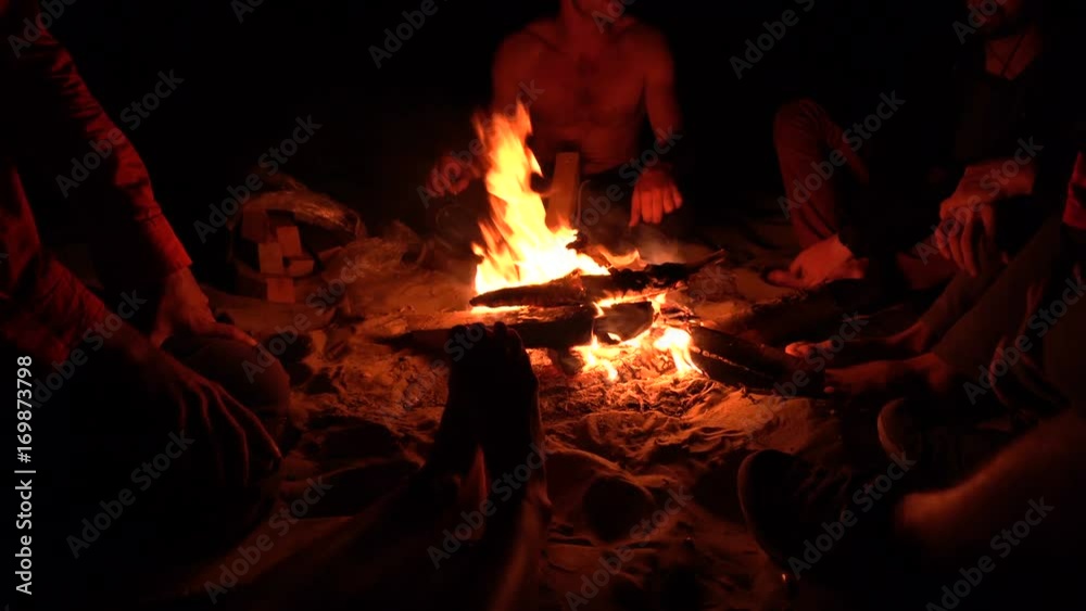 Group of Friends Sitting near bonefire at Night and Hanging Out. 4K UHD . Group of Friends Sitting near bonefire at Night and Hanging Out. 4K UHD .