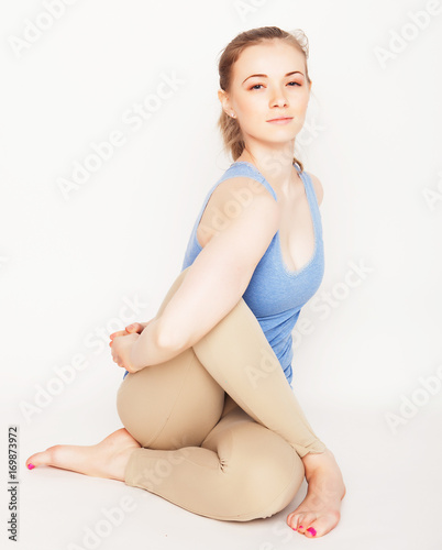 young woman practicing yoga in studio