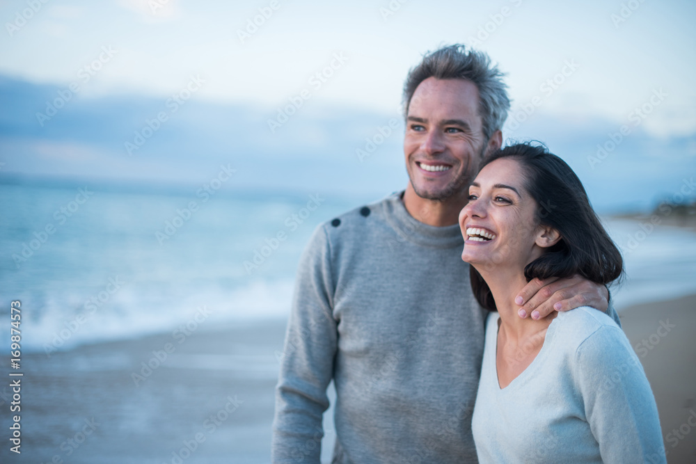 Portrait of a couple walking on the beach Portrait of a couple walking on the beach