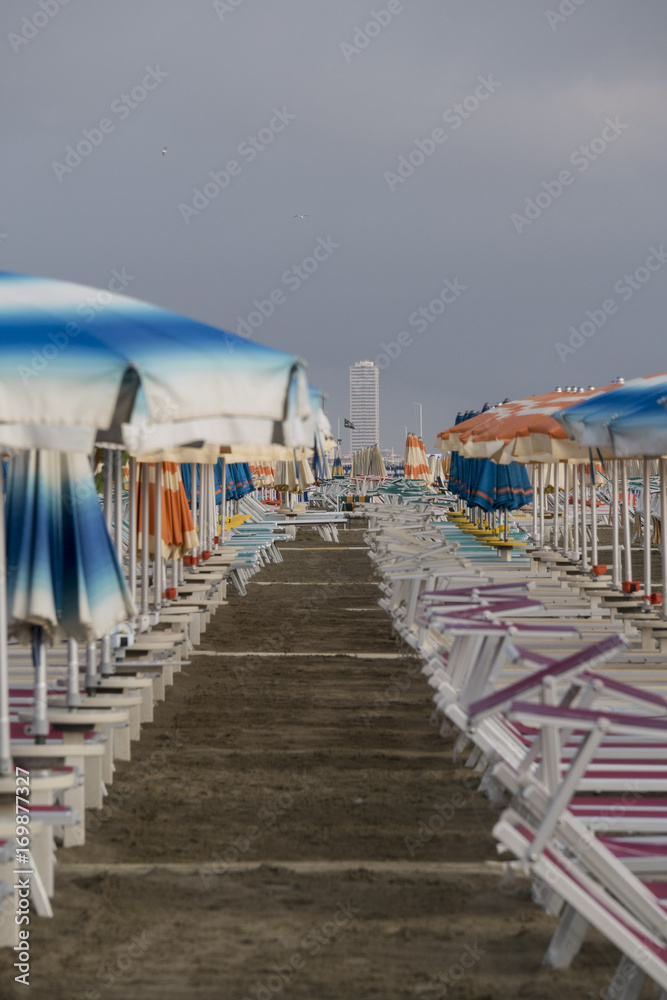 Fototapeta premium Beach with parasols and sun loungers in Italy
