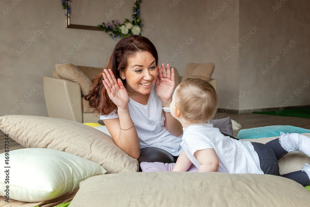 Young mother playing with her child