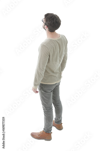 modern young man looks confidently forward. Photo in full length