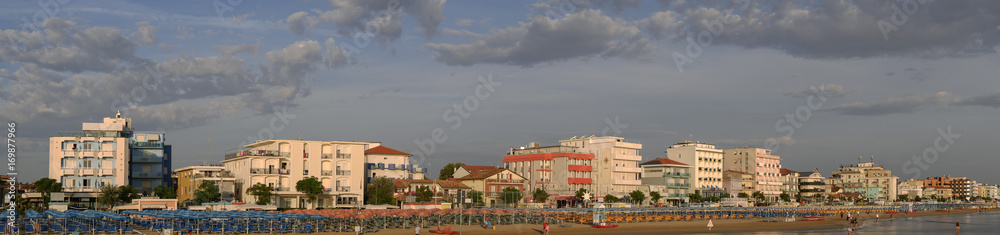 Panoramic view of the beach and bathing establishments of the Romagna Riviera at dawn.