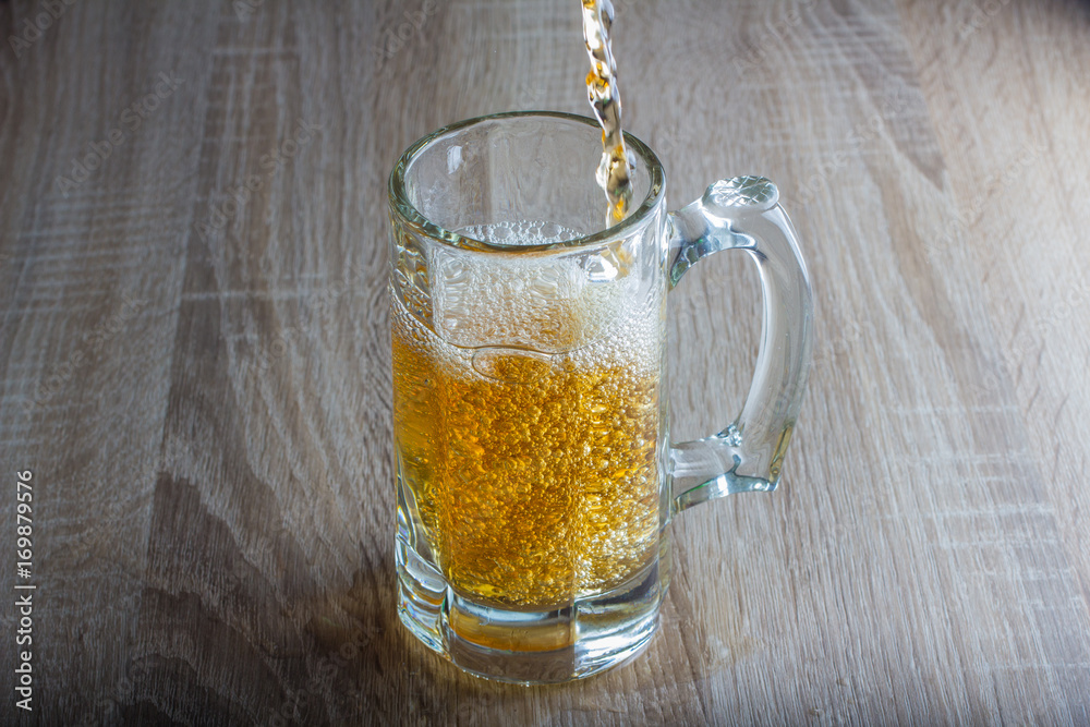 glass of beer on a woody background glass of beer on a woody background