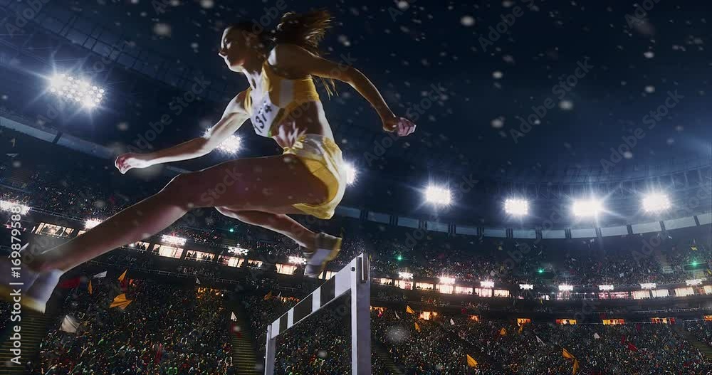 Track and field runner hurdles on sports arena Track and field runner hurdles on sports arena