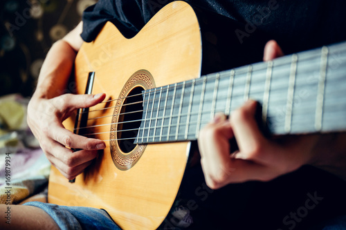 musician playing acoustic guitar, live music background