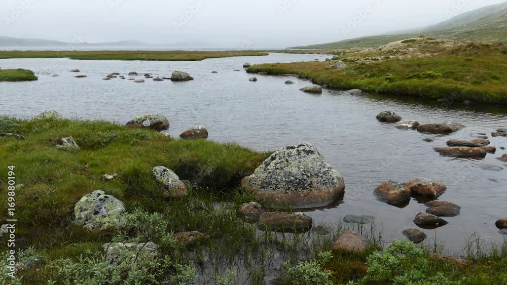 Lake with stone and mist in Voringfossen Norway Lake with stone and mist in Voringfossen Norway