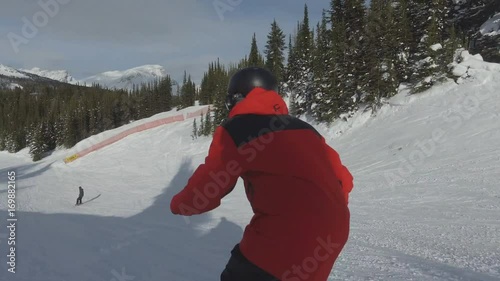 Freestyle skier does small drop going down hill photo