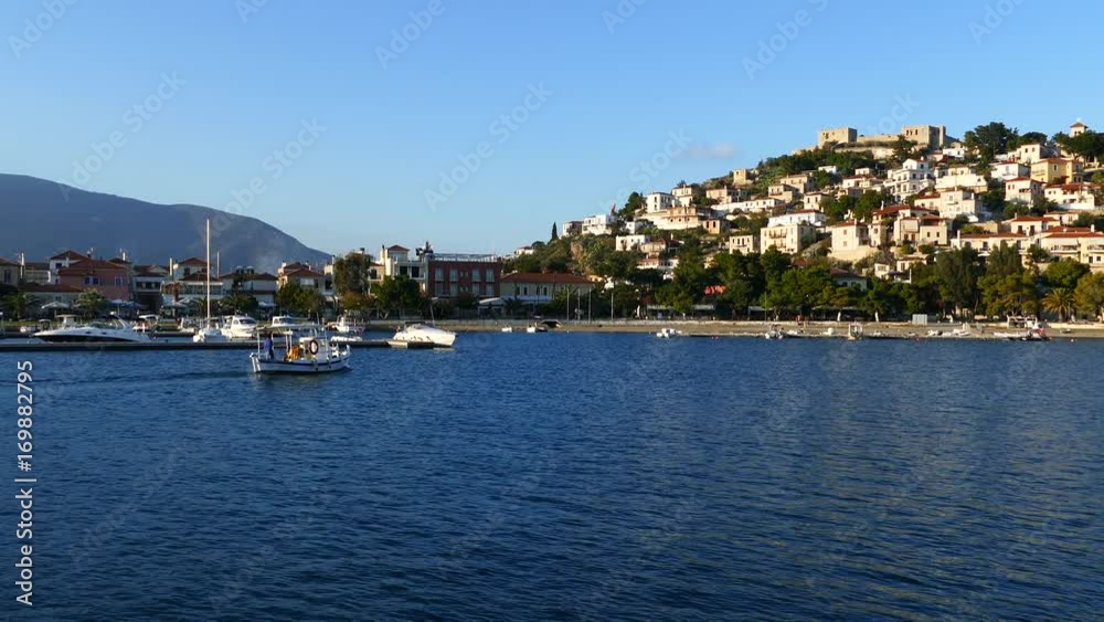 Small fishing boat passing by at the town Paralio Astros in Greece Small fishing boat passing by at the town Paralio Astros in Greece