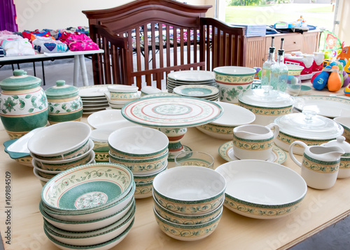 Tables of dishes and baby goods at a suburban garage sale