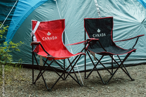 Armchairs and tent at camping site in the forest British Columbia Canada.