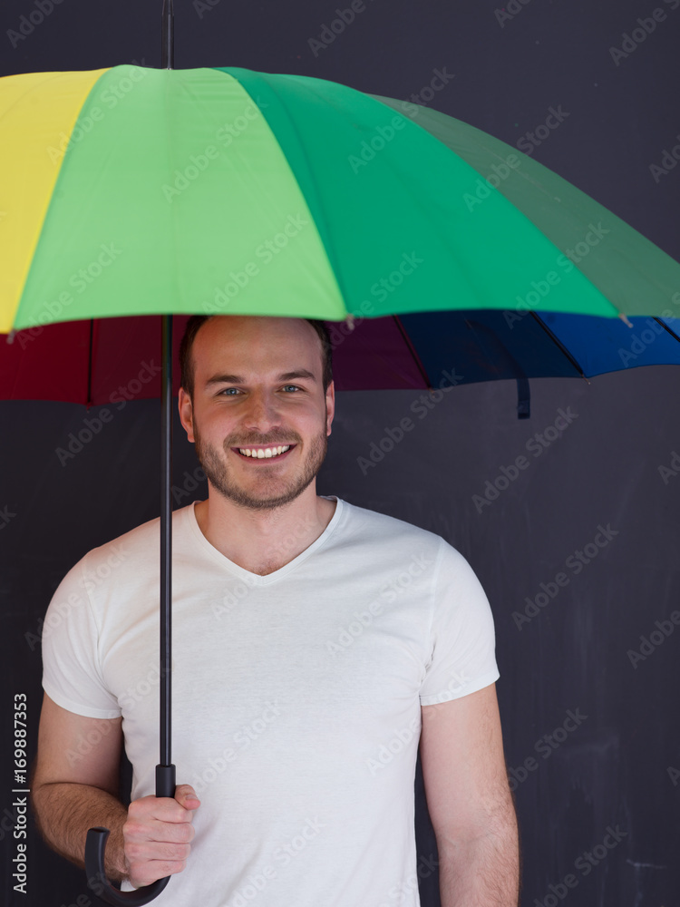 handsome man with a colorful umbrella StockFoto Adobe Stock