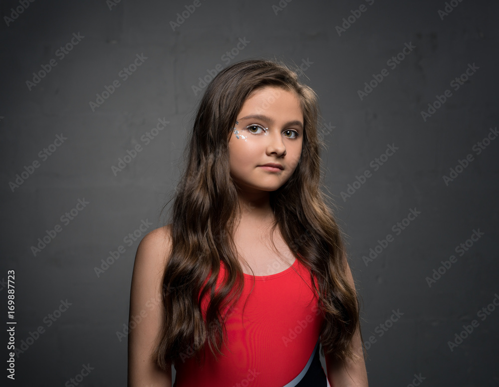 Fototapeta premium Teenaged pretty brunette against gray background