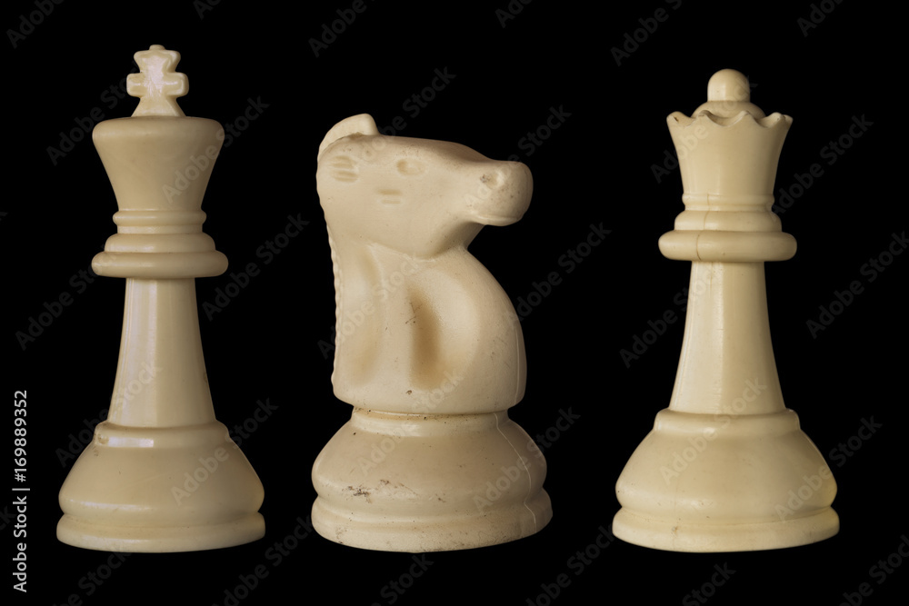 Chess pieces. White king, horse and queen. Black background Chess pieces. White king, horse and queen. Black background