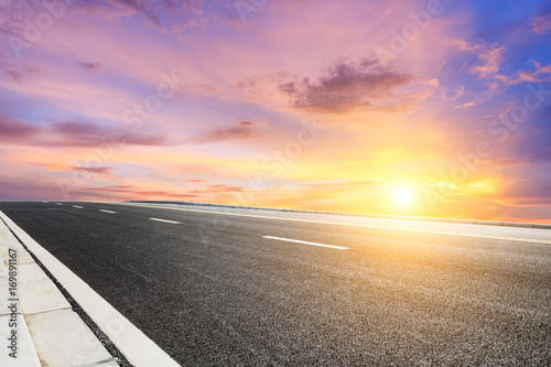 Asphalt road and beautiful sky landscape at sunset