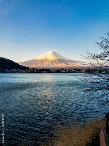Mountain Fuji in the morning with reflection on the blue lake