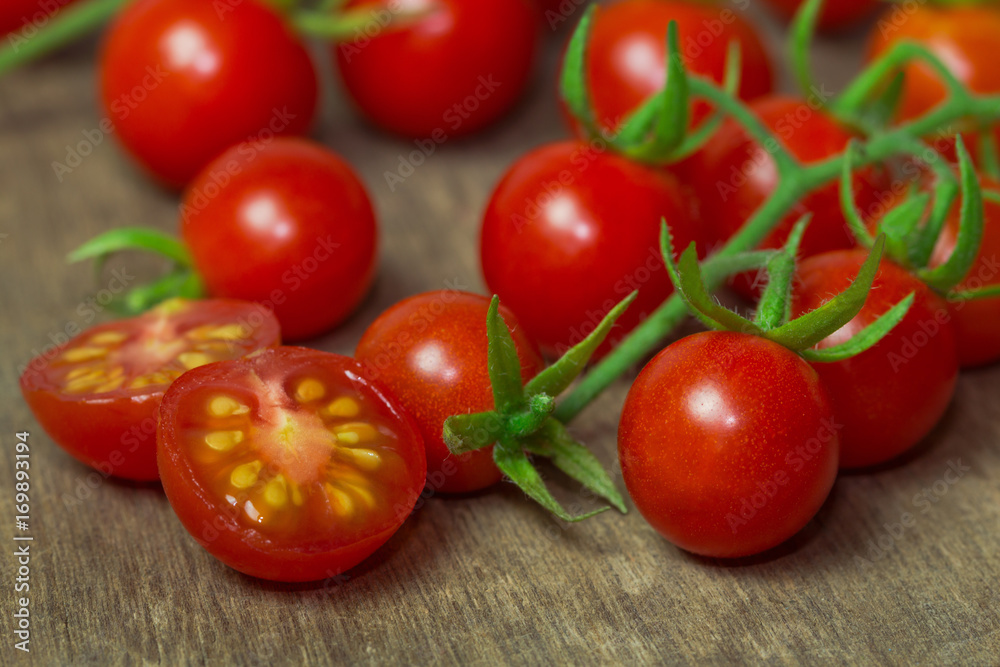 Fresh cherry tomato on rustic wood table. Close up lovely cherry tomato for background or wallpaper. Prepare fresh cut cherry tomato for home cooking look so delicious. Macro concept with copy space. Fresh cherry tomato on rustic wood table. Close up lovely cherry tomato for background or wallpaper. Prepare fresh cut cherry tomato for home cooking look so delicious. Macro concept with copy space.