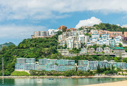 Luxury residences on waterfront and mountain with views of Repulse Bay and beach. The houses feature a contemporary classic architectural style with detail articulation of moldings and fenestration.
